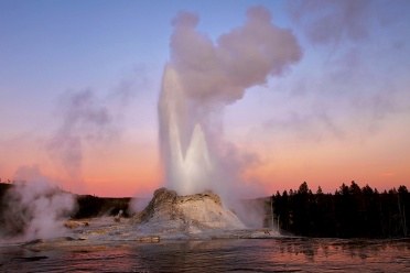 Castle Geyser eruption at sunset