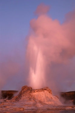 Castle Geyser erupting at twilight